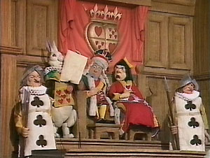 In the Courtroom: the King and Queen of Hearts: "Give your evidence," said the King.