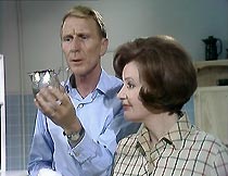 Frank Marker (Alfred Burke) and Helen Mortimer (Pauline Delaney) do the washing up.